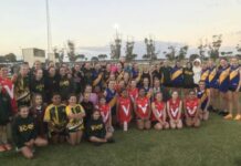 Young girls kicking goals